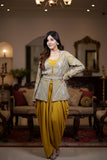 Woman in traditional outfit standing in a decorated room with furniture and mirrors.