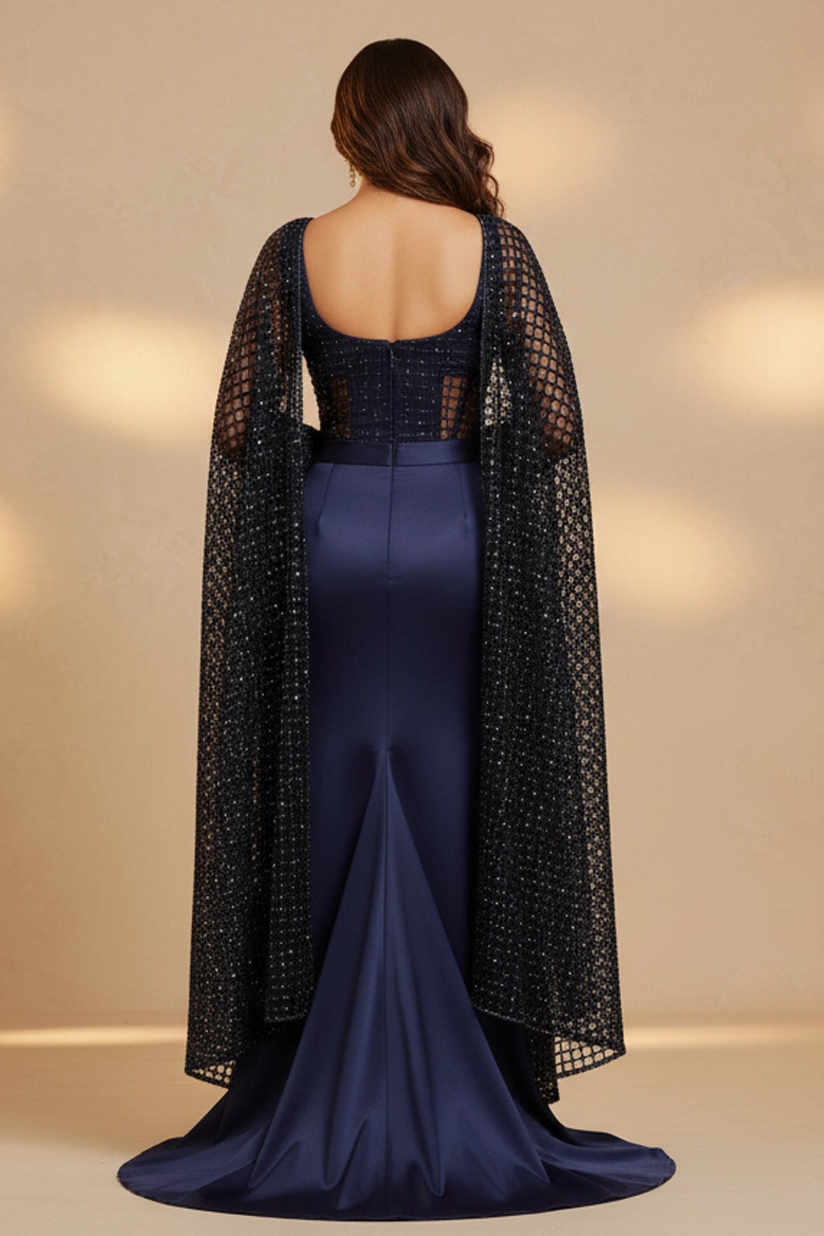 Navy blue evening gown with a black embroidered jacket on a beige background