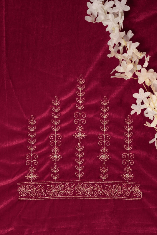 Decorative red fabric with white floral embroidery and a branch of white flowers on a matching red background.
