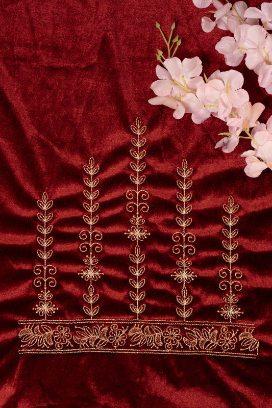 Embroidered fabric with gold patterns on a red background
