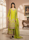 Woman wearing a green traditional outfit with intricate patterns in a well-lit room.