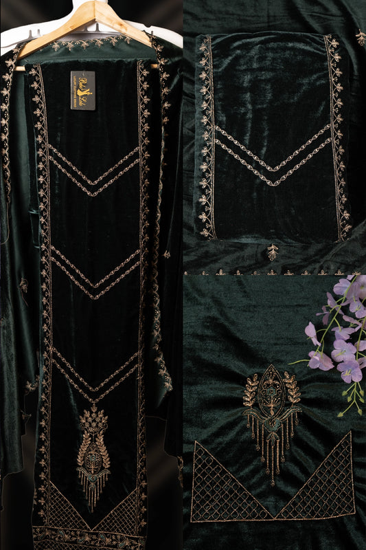 Dark green velvet garment with gold embroidery on a hanger against a black background.