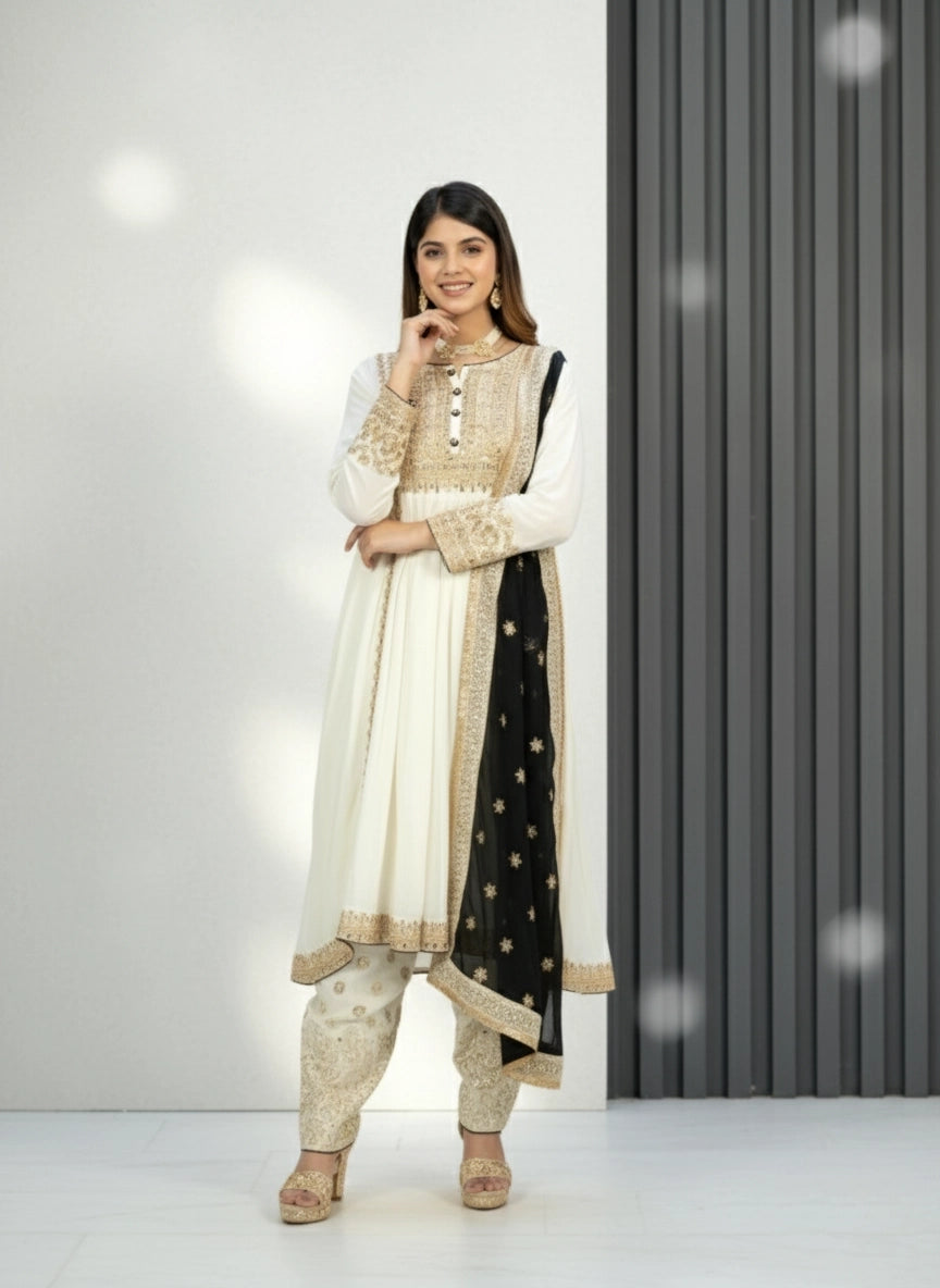 Woman wearing a traditional outfit with a white and black dress against a plain background
