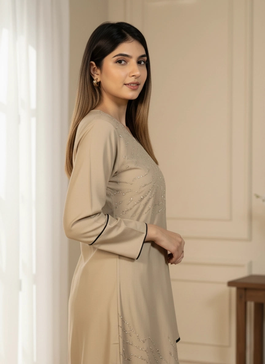Woman wearing a beige dress with black trim indoors
