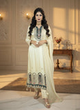 Woman in a traditional outfit with intricate designs in a well-lit room.