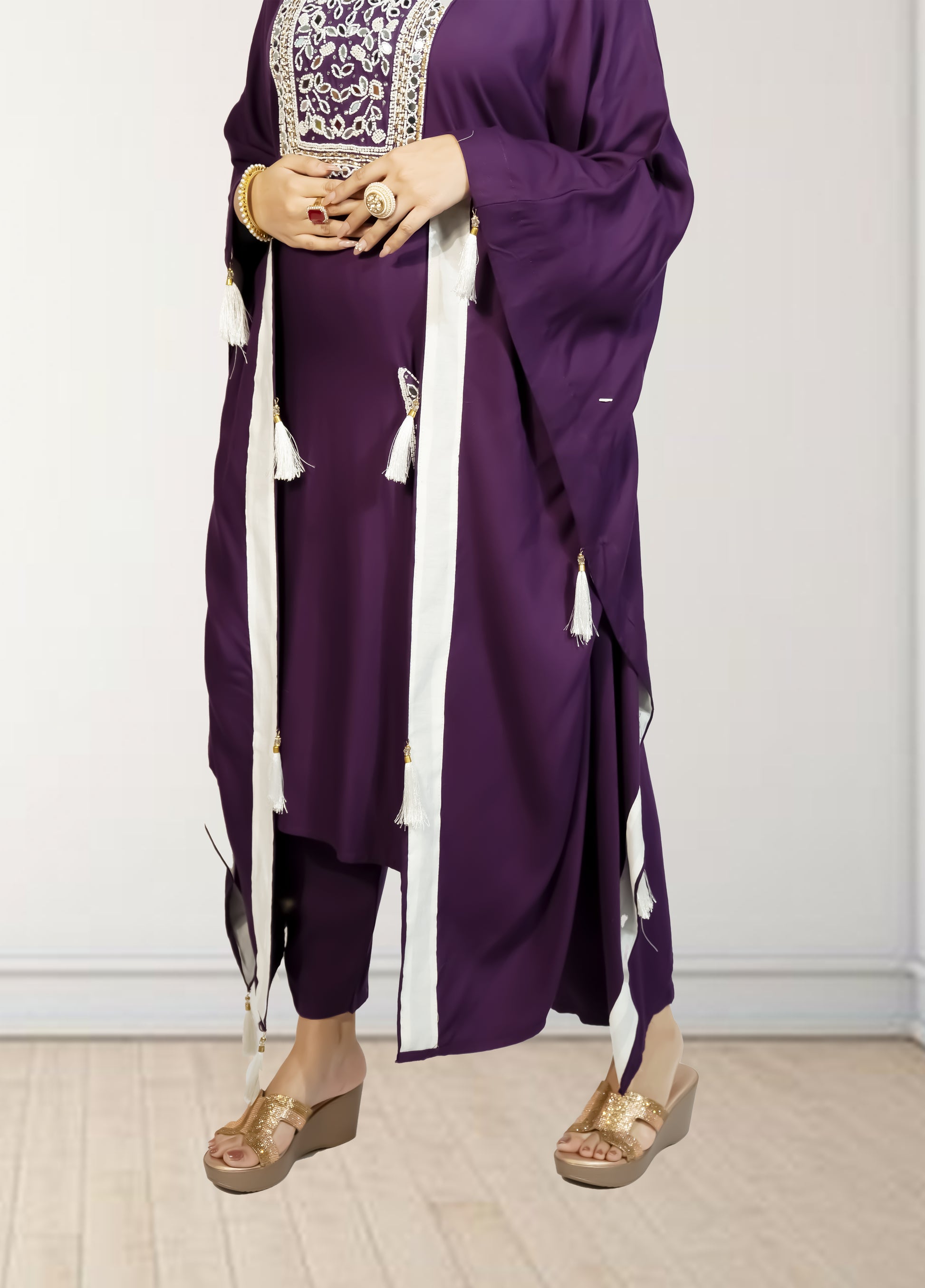 Purple traditional outfit with white accents on a plain background