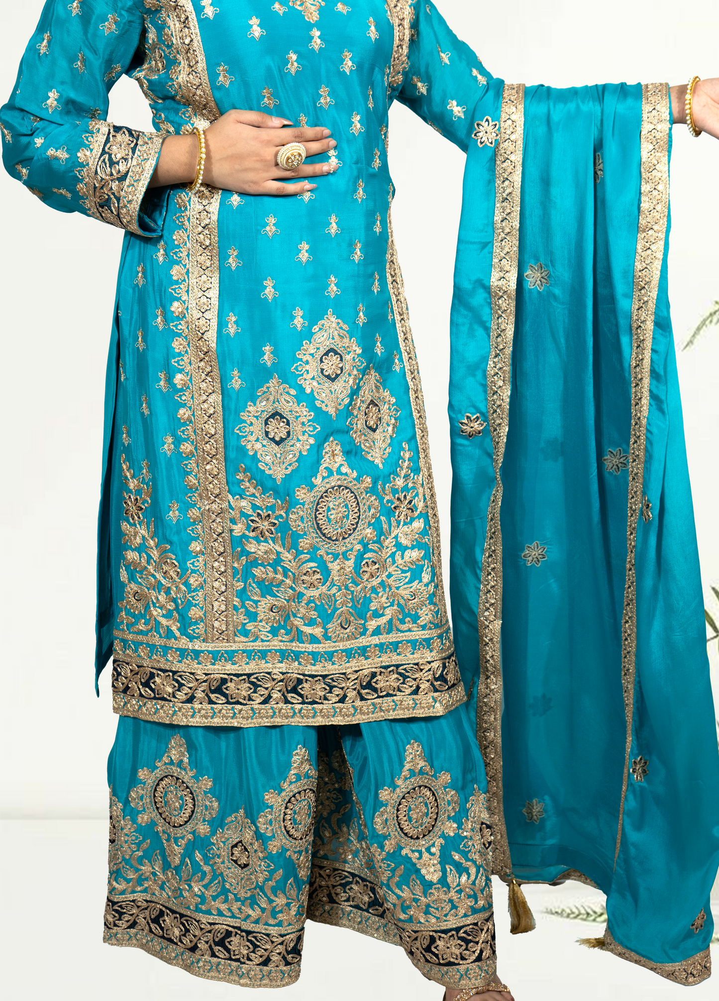 Turquoise embroidered traditional outfit with dupatta on a white background
