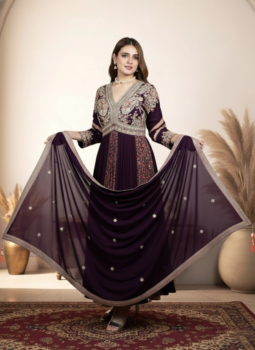 Woman in a purple embroidered traditional outfit with a flowing skirt in a decorated room.
