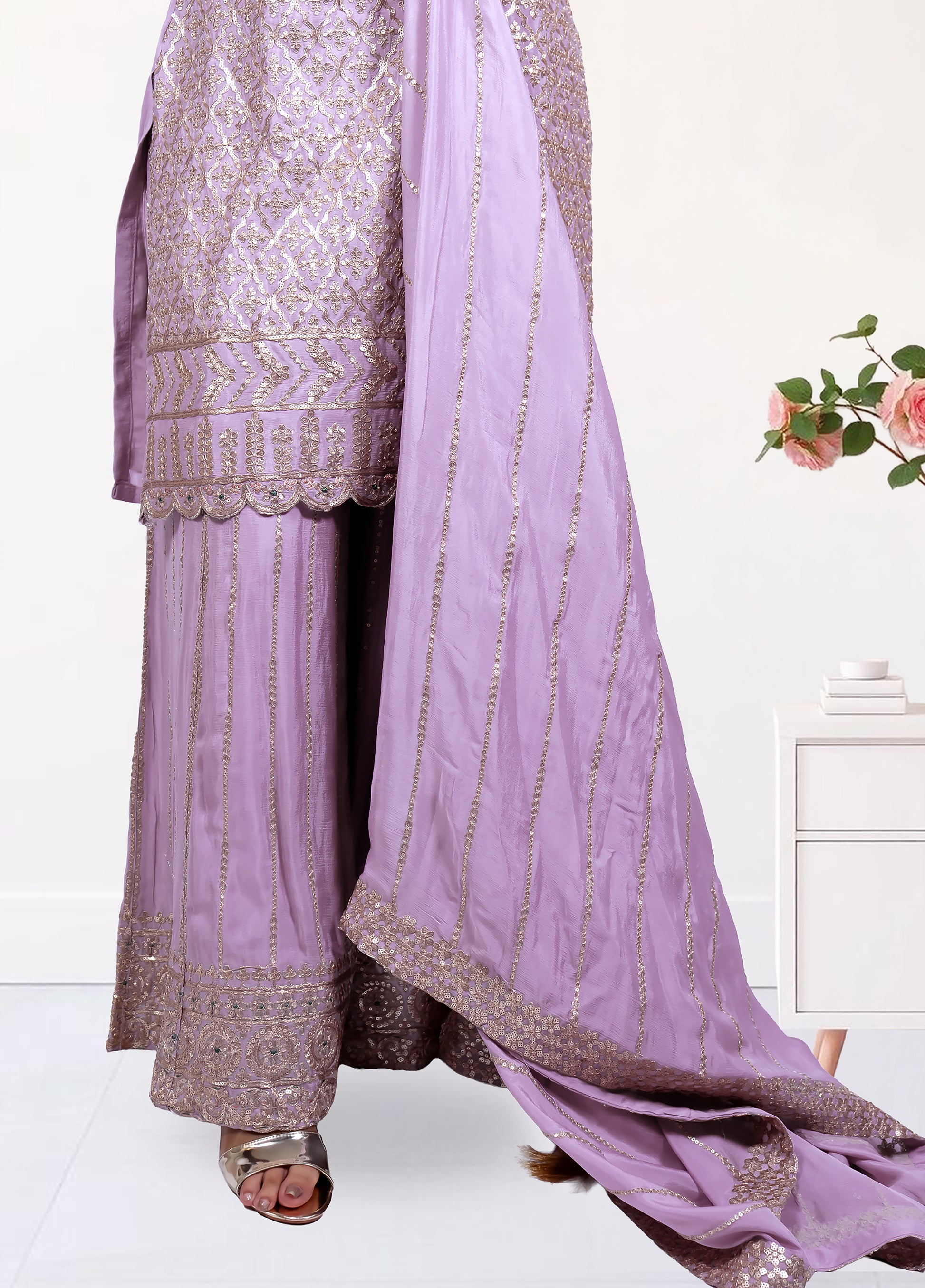 Traditional outfit with embroidered top and pants, draped with a matching dupatta on a white background.
