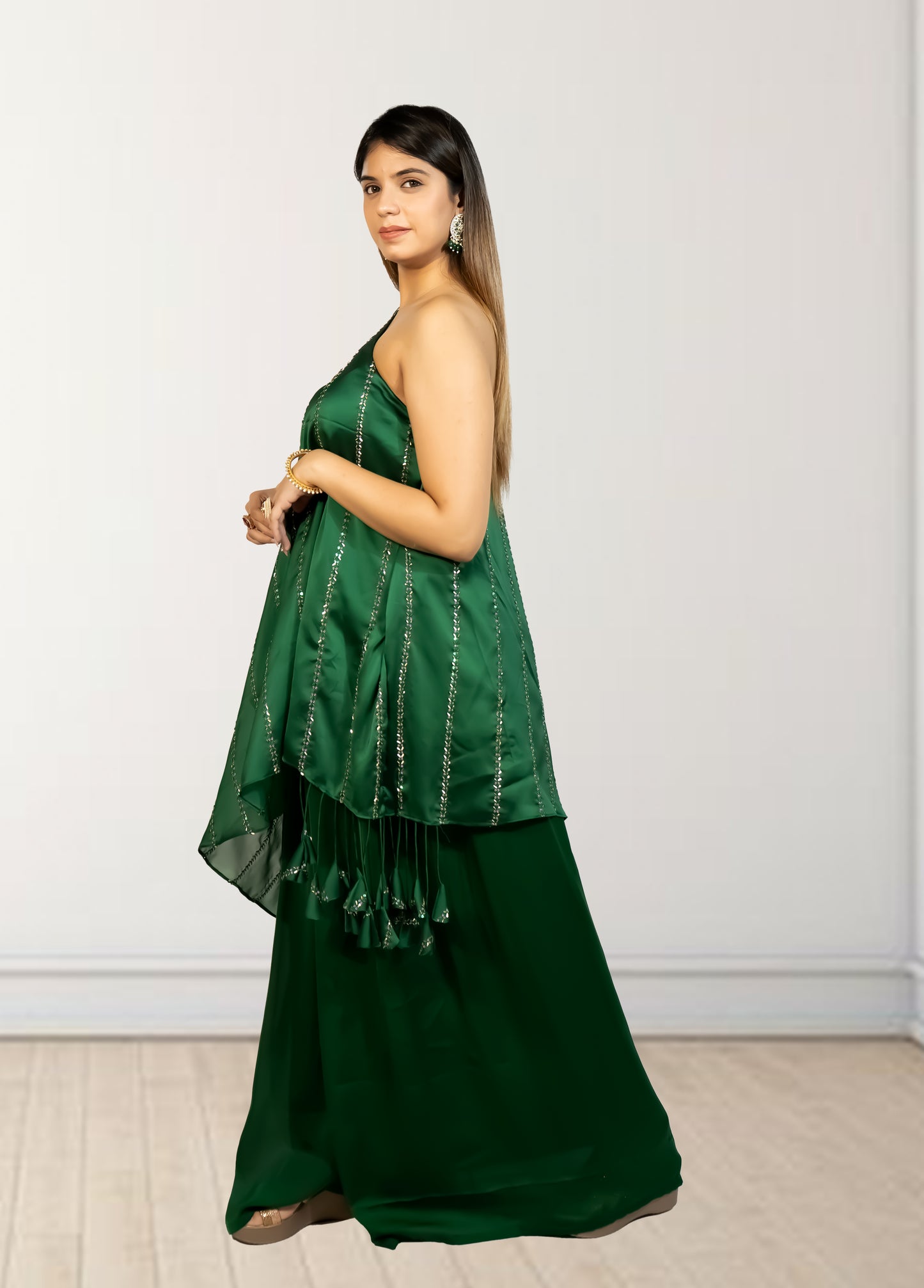 Woman wearing a green saree with a white background
