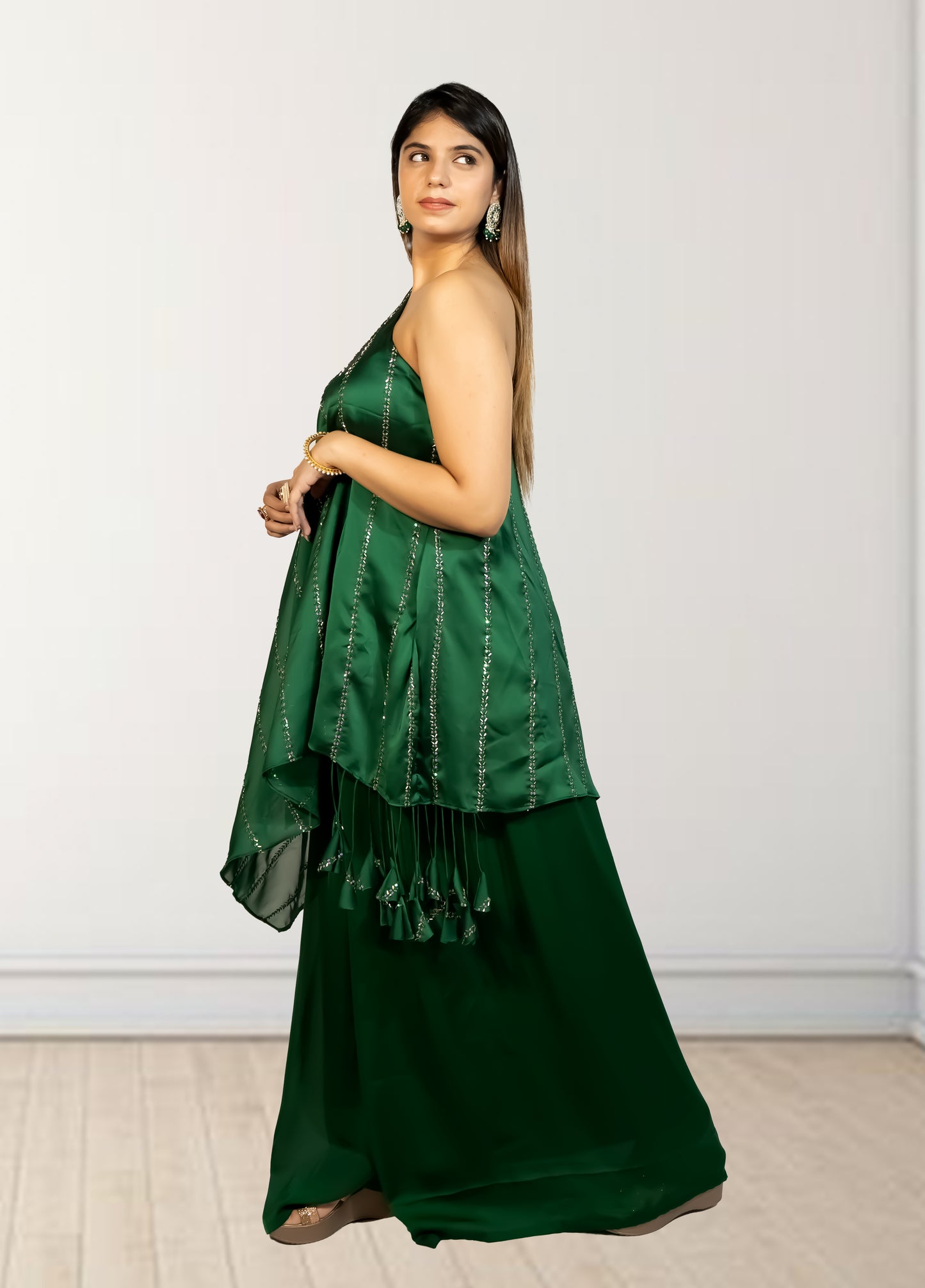 Woman wearing a green traditional outfit with a white background