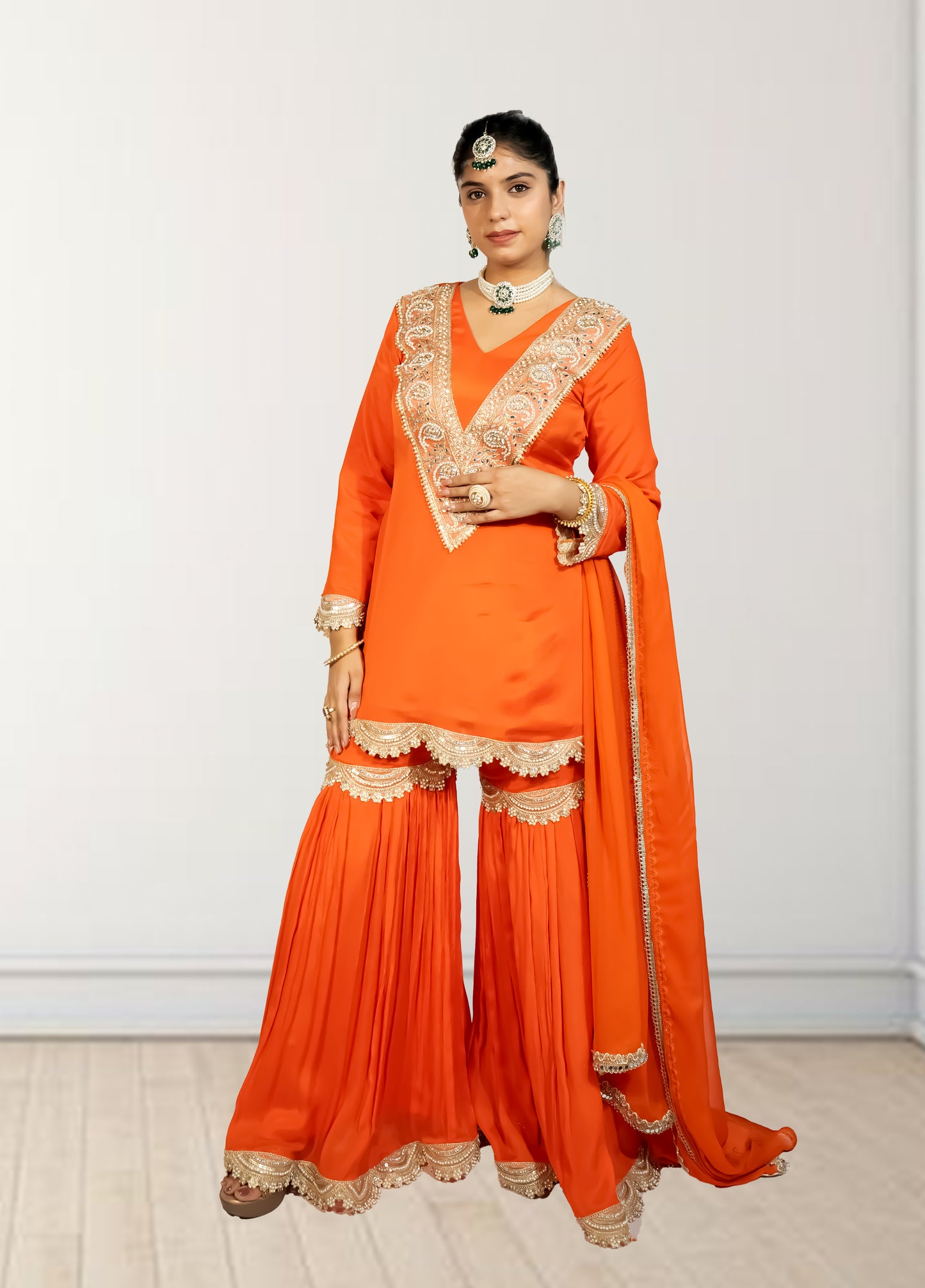Orange traditional outfit with gold embroidery on a white background