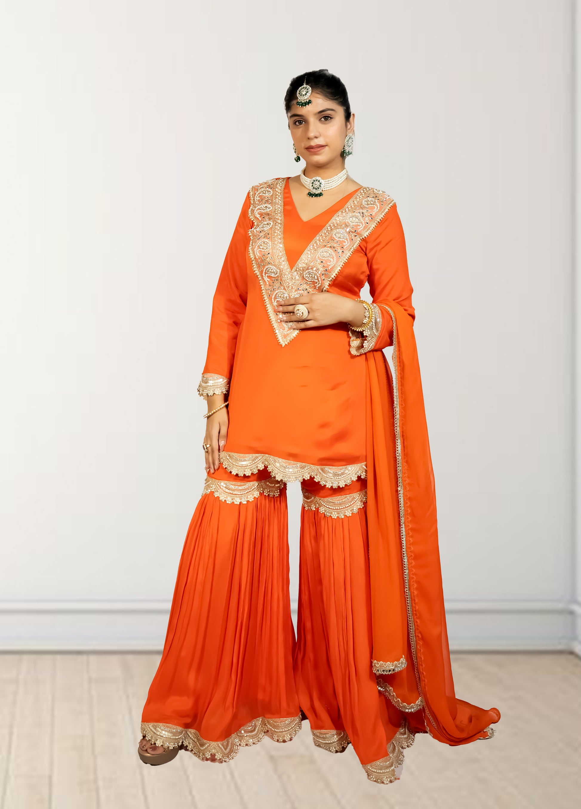 Orange traditional outfit with gold embroidery on a white background