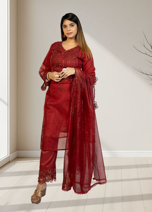 Woman wearing a red lace outfit standing indoors.