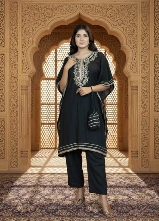 Woman in black traditional outfit with embroidery standing in a decorative archway.