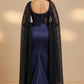 Navy blue evening gown with a black embroidered jacket on a beige background