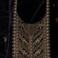 Black fabric with gold embroidery on a dark background