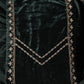 Dark green velvet fabric with gold embroidery on a dark background