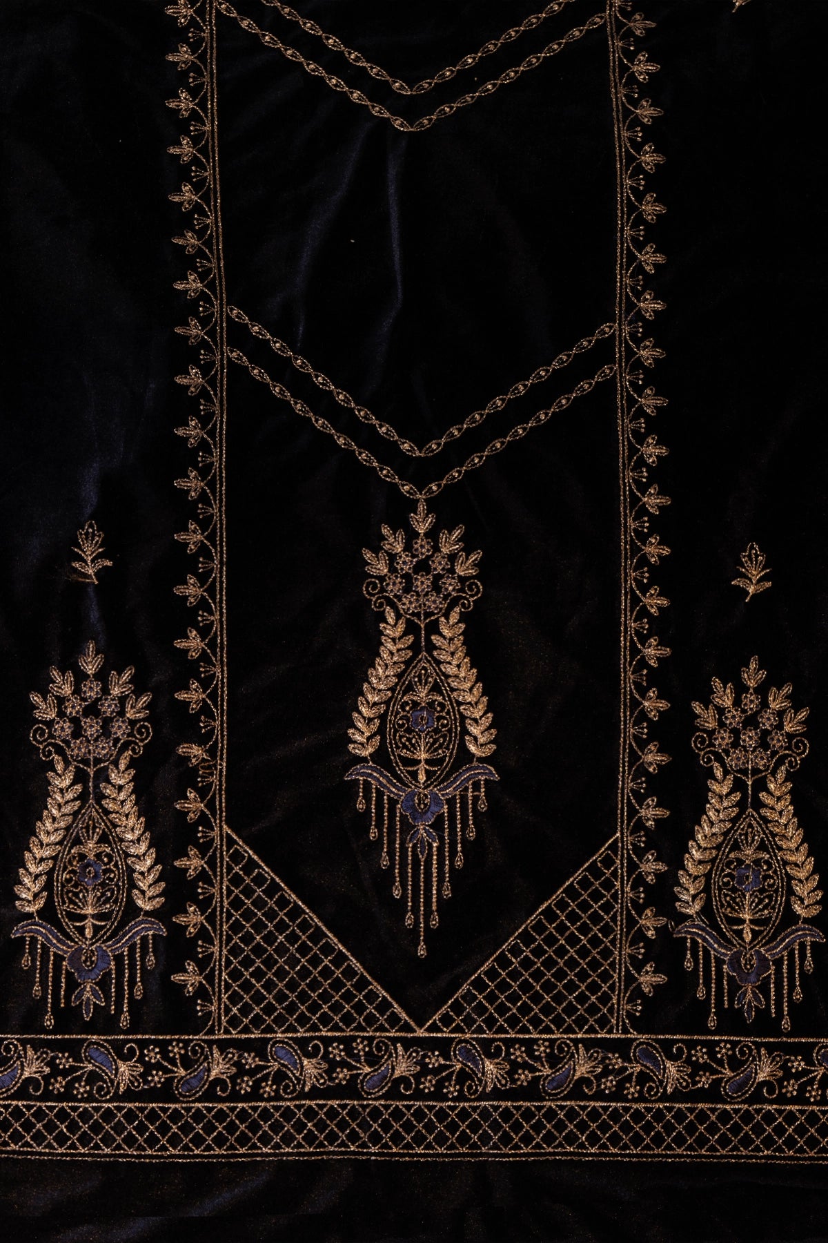 Decorative fabric with intricate gold embroidery on a black background