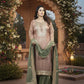 Woman in traditional outfit standing in a decorative garden setting