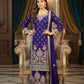 Woman in a traditional purple embroidered outfit sitting on an ornate chair.