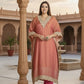 Woman in a traditional outfit standing in an architectural setting