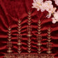 Embroidered fabric with gold patterns on a red background