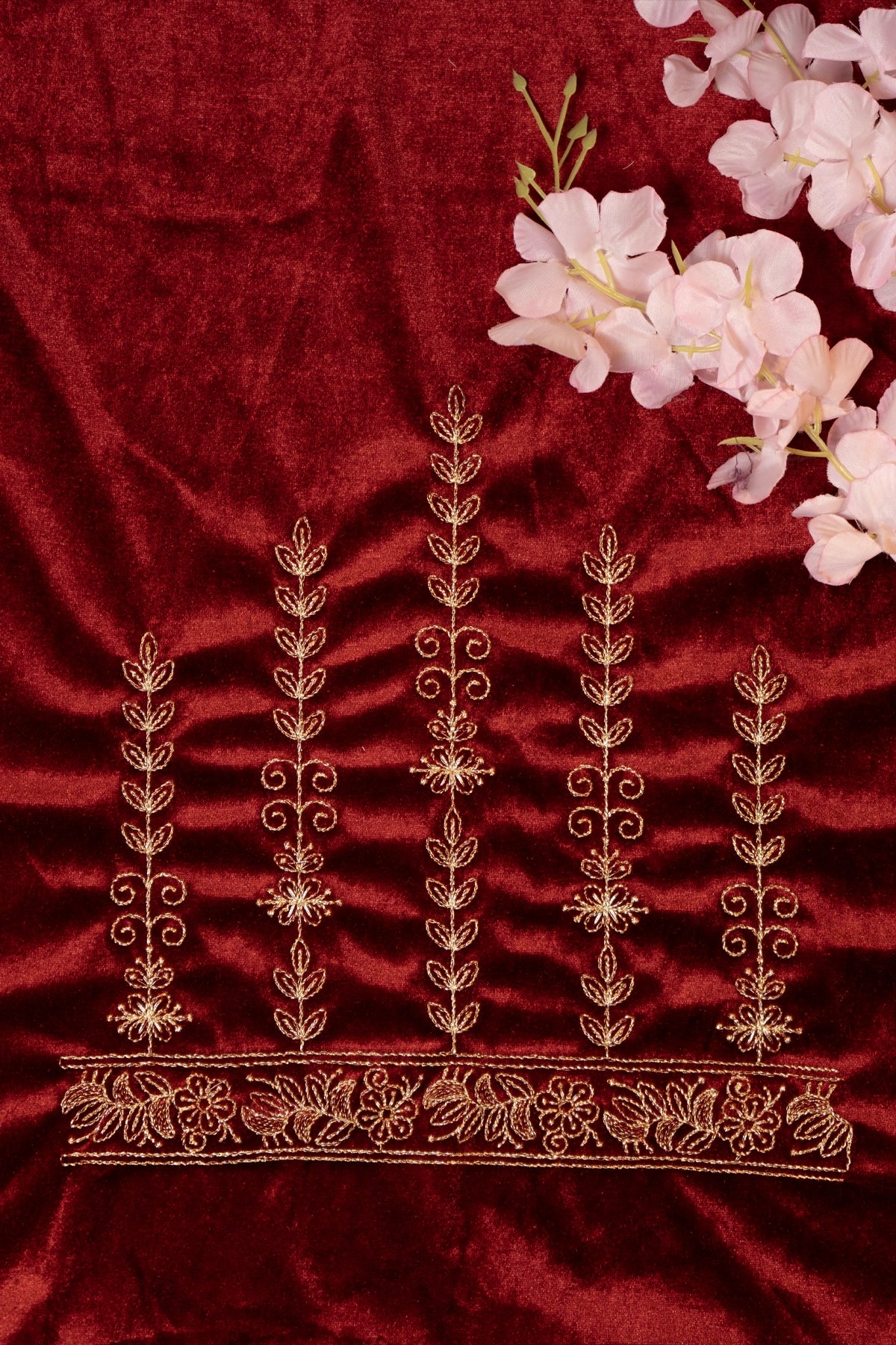 Embroidered fabric with gold patterns on a red background