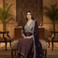 Woman in traditional attire sitting on a decorative chair in an elegant room.