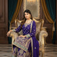 Woman in a traditional purple outfit sitting on an ornate chair in a luxurious room.