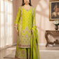 Woman wearing a green traditional outfit with intricate patterns in a well-lit room.