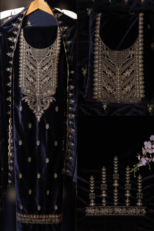 Navy blue embroidered garment with intricate gold detailing on a dark background