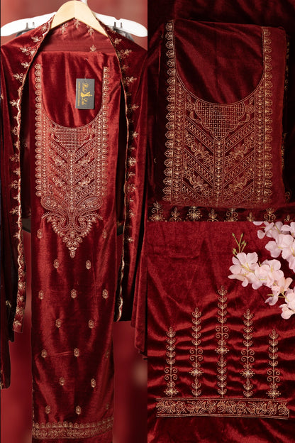 Maroon embroidered traditional outfit with gold detailing on a hanger.