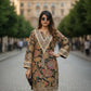 Woman wearing a patterned dress on a city street