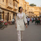 Woman walking on a street in an urban setting with traditional attire