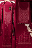 Maroon embroidered traditional outfit with detailed patterns on a red background