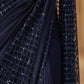 Navy blue fabric with sequin detailing on a blurred background