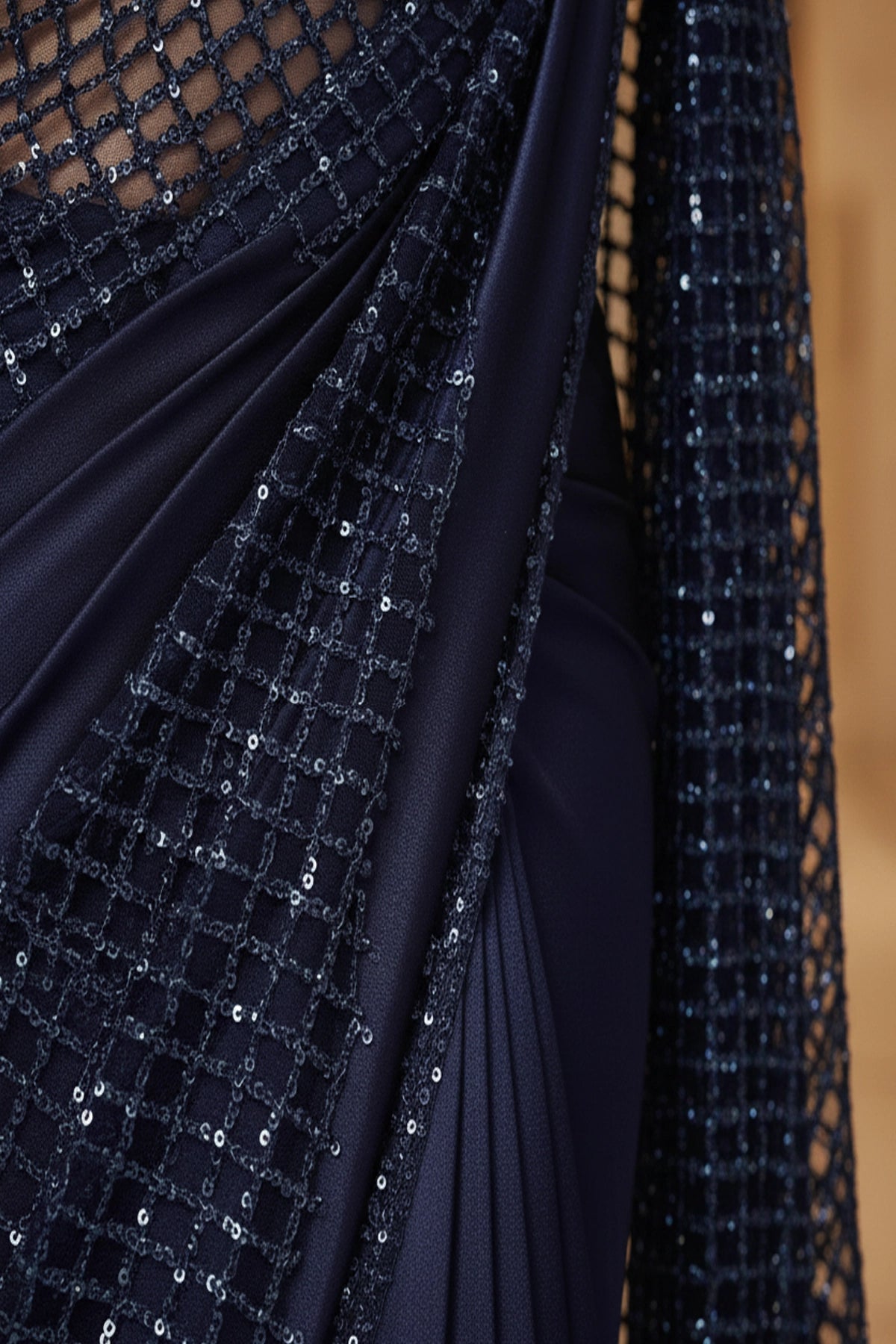 Navy blue fabric with sequin detailing on a blurred background