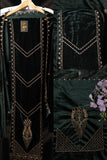 Dark green velvet garment with gold embroidery on a hanger against a black background.