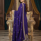 Woman in a purple traditional outfit with gold details in an elegant room.