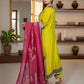 Woman holding a bright pink dupatta with a gold border in a room with a mirror and shelves.
