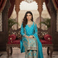 Woman in a blue traditional outfit standing in an ornate room with a chandelier.