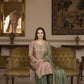 Woman in traditional attire sitting on a green sofa in an ornate room with mirrors and tapestries.