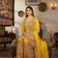 Woman in a yellow and gold traditional outfit sitting in an ornate room.