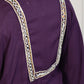 Purple garment with intricate white embroidery on a plain background