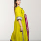 Woman wearing a bright yellow traditional outfit with a pink dupatta against a white background