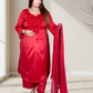 Woman in a red traditional outfit with a matching dupatta indoors.