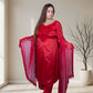 Woman wearing a red traditional outfit with a matching dupatta in a well-lit room.