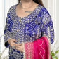 Woman wearing a blue embroidered traditional outfit with a pink dupatta.