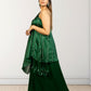 Woman wearing a green traditional outfit with a white background